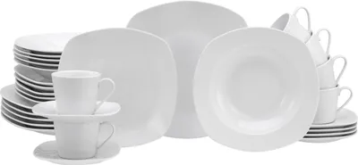 A collection of white porcelain dinnerware, including plates, bowls, and cups, arranged on a white background.