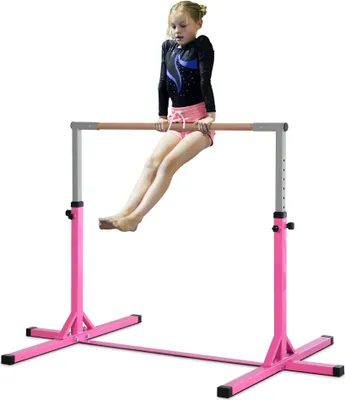 A young girl is performing on a gymnastics bar.