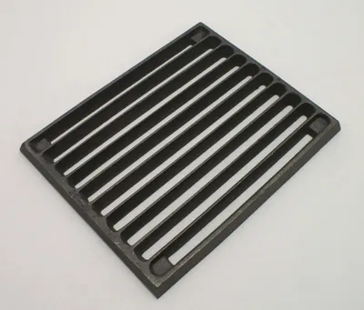 A cast iron grate on a white background.