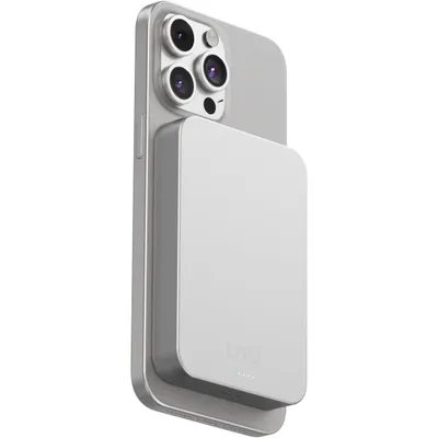A silver smartphone with a magnetic wireless power bank attached to its back.