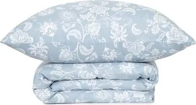 A folded duvet and pillow with a floral pattern on a white background.