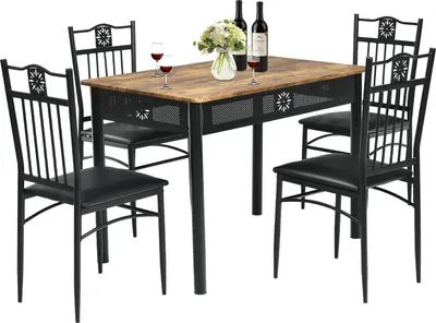 A dining table set with four chairs, two bottles of wine, and a vase of flowers on the table.