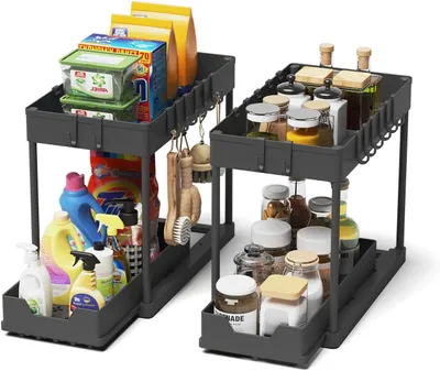 Two gray under-sink organizers filled with cleaning supplies and kitchen spices.