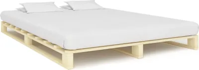 A wooden bed frame with a white mattress and two white pillows.