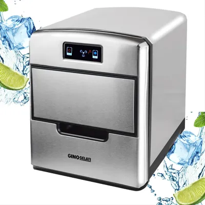 A stainless steel ice maker with decorative ice cubes and lime slices around it.