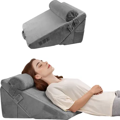 A woman is lying down on a wedge pillow set.