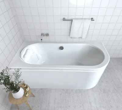 A white bathtub in a tiled bathroom.
