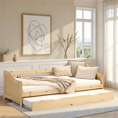A wooden daybed with a pull-out trundle bed is set up in a bright, airy room with a window and wall art.