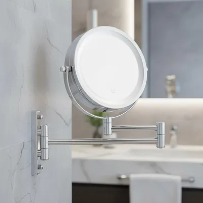 A close-up shot of a wall-mounted makeup mirror with LED lighting in a bathroom.