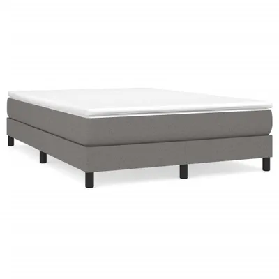 A studio shot of a box spring bed frame with a mattress on top, presented against a white background.
