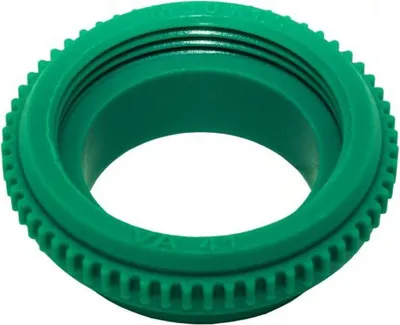A green plastic fitting with threaded interior and a serrated exterior edge.