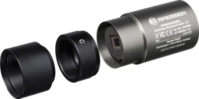 A disassembled astronomical camera with its accessories, shown against a white background.