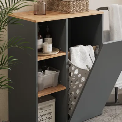 A bathroom cabinet with open shelves and a laundry basket.