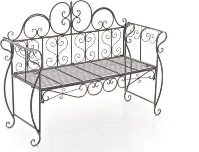 A bronze garden bench with ornate scrollwork.