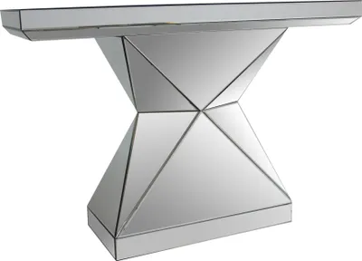 A mirrored console table with a geometric base.
