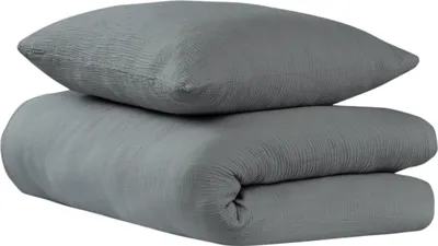 A folded duvet and pillow in dark gray.