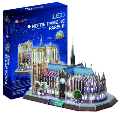 A 3D puzzle model of Notre Dame Cathedral with LED lighting, displayed next to its packaging.