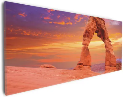 Produktbild von Wallario Premium Leinwandbild Steinbogen vor einem farbenfrohen Himmel in lila-rot in Größe 30 x 75 cm