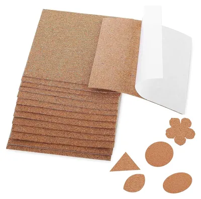 A stack of rectangular cork sheets with some cut-out shapes of cork in various forms.