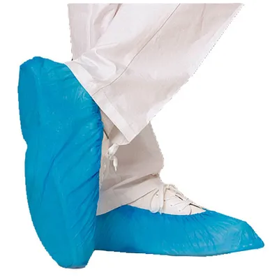 A person wearing white pants and blue shoe covers.