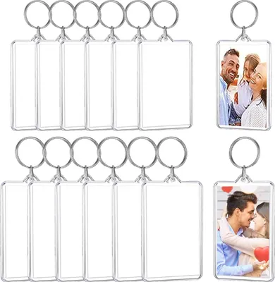 A collection of blank and photo-filled acrylic keychains arranged in rows.