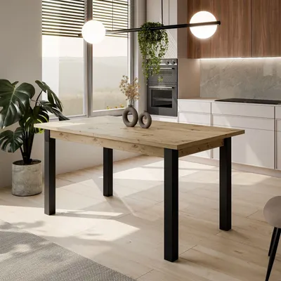 A dining table in a modern kitchen setting with natural light.