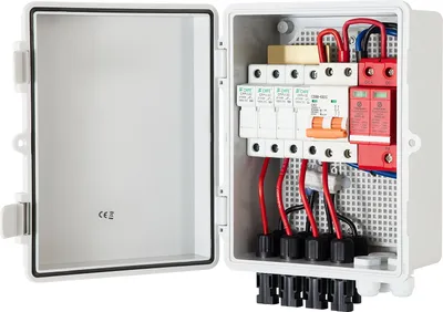 An open white electrical junction box containing solar power components.