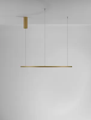 A modern pendant light fixture with a long, thin gold bar suspended by thin wires from a gold cylindrical ceiling mount.