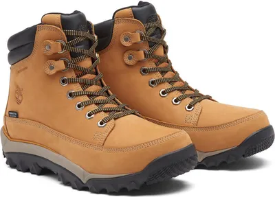 A pair of tan Timberland hiking boots on a white background.