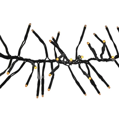 A close-up view of a string of warm white LED cluster lights against a white background.