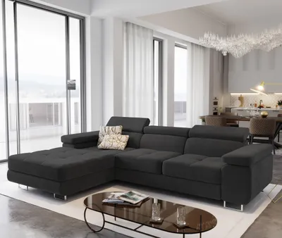 A modern living room with a large sectional sofa and a coffee table.