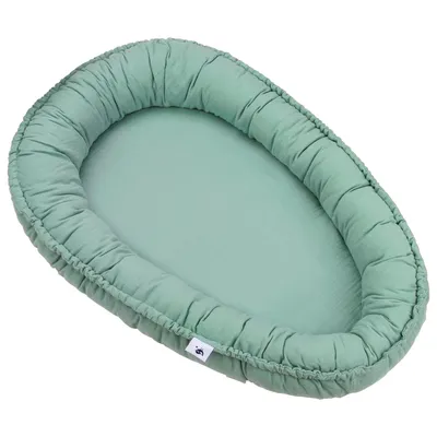 A green baby nest on a white background.