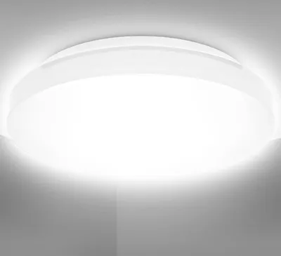 A close-up view of a white, circular ceiling light fixture mounted on a white ceiling.