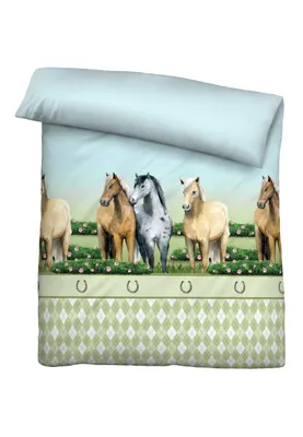 A duvet cover with a print of horses in a field.