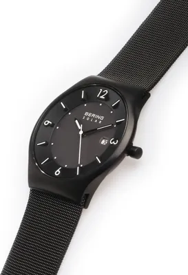A black Bering solar watch with a mesh strap is shown against a white background.