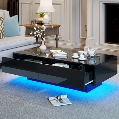 A modern living room scene featuring a black high-gloss coffee table with blue LED lighting.
