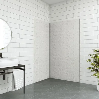 A modern bathroom corner with white subway tile walls, a sink, and a shower enclosure.