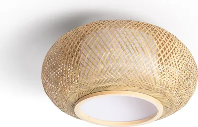 A close-up view of a round ceiling light made of woven bamboo with a white diffuser.