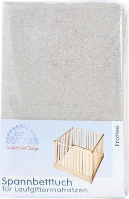 The image shows the packaging of a baby crib sheet, with a small illustration of a crib.