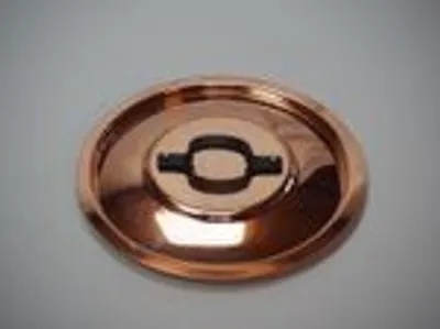 A copper lid with a black insert is shown on a plain background.