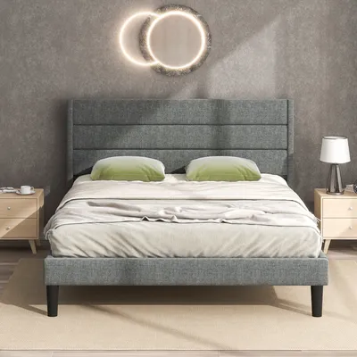 A bedroom scene with a bed, nightstands, and wall decor.