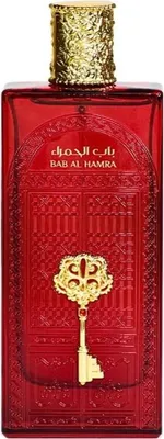 A red perfume bottle with gold accents and Arabic writing.