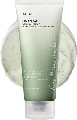 A tube of Anua Heartleaf Quercetinol Pore Deep Cleansing Foam is shown against a light gray, swirled background.