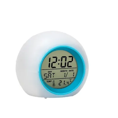 A digital alarm clock with a blue rim and a digital display showing the time, day, month, date, and temperature.
