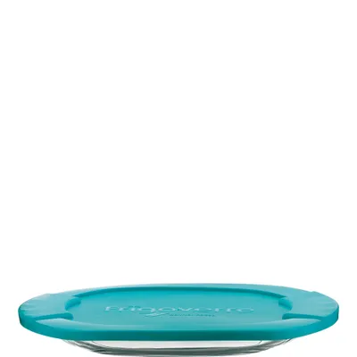 A close-up, low-angle shot of a round glass dish with a turquoise lid, set against a white background.