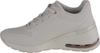 A side view of a beige Skechers sneaker.