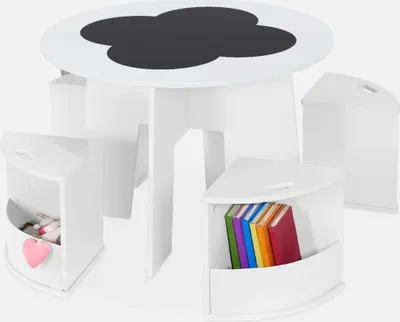 A white children's table with a cloud-shaped chalkboard top and four white corner stools, two of which are visible and contain books and toys.