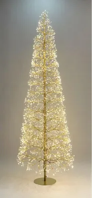 A tall, slender Christmas tree decorated with many small, bright white lights, standing on a circular gold base.