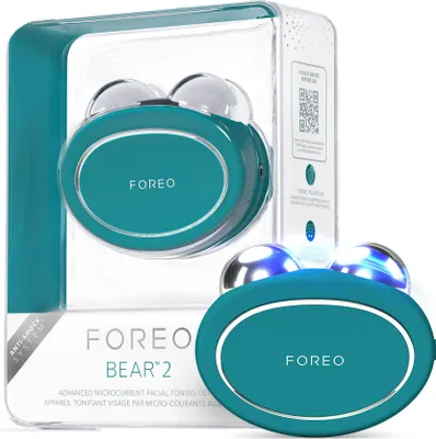 A teal FOREO BEAR 2 smart microcurrent facial toning device is shown in its packaging, with a second device visible in the foreground.