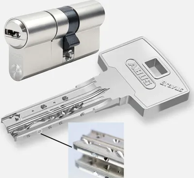 A lock cylinder and a key are displayed against a plain background, with a close-up inset showing the key's intricate design.